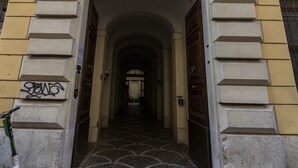 A building entrance with a tiled floor and a metal gate. - Arch Rome Suites (Rome)