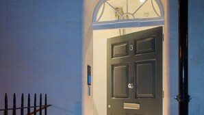 A dark door with a number '3' above it, set within an arched doorway, leading to a tiled floor. - Bath Circle (Bath)