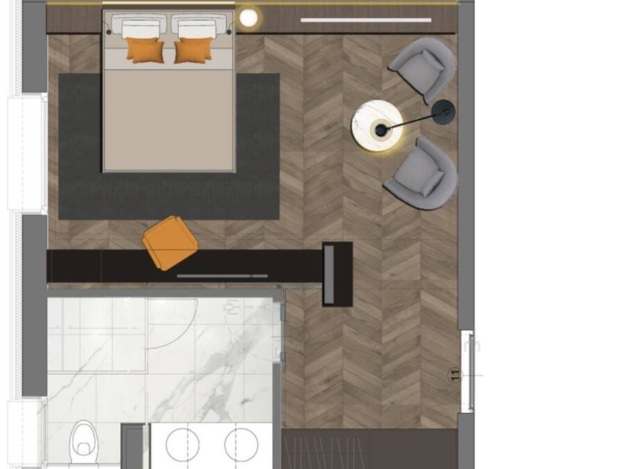 Een hotelkamer met een bed, zithoek en kitchenette.