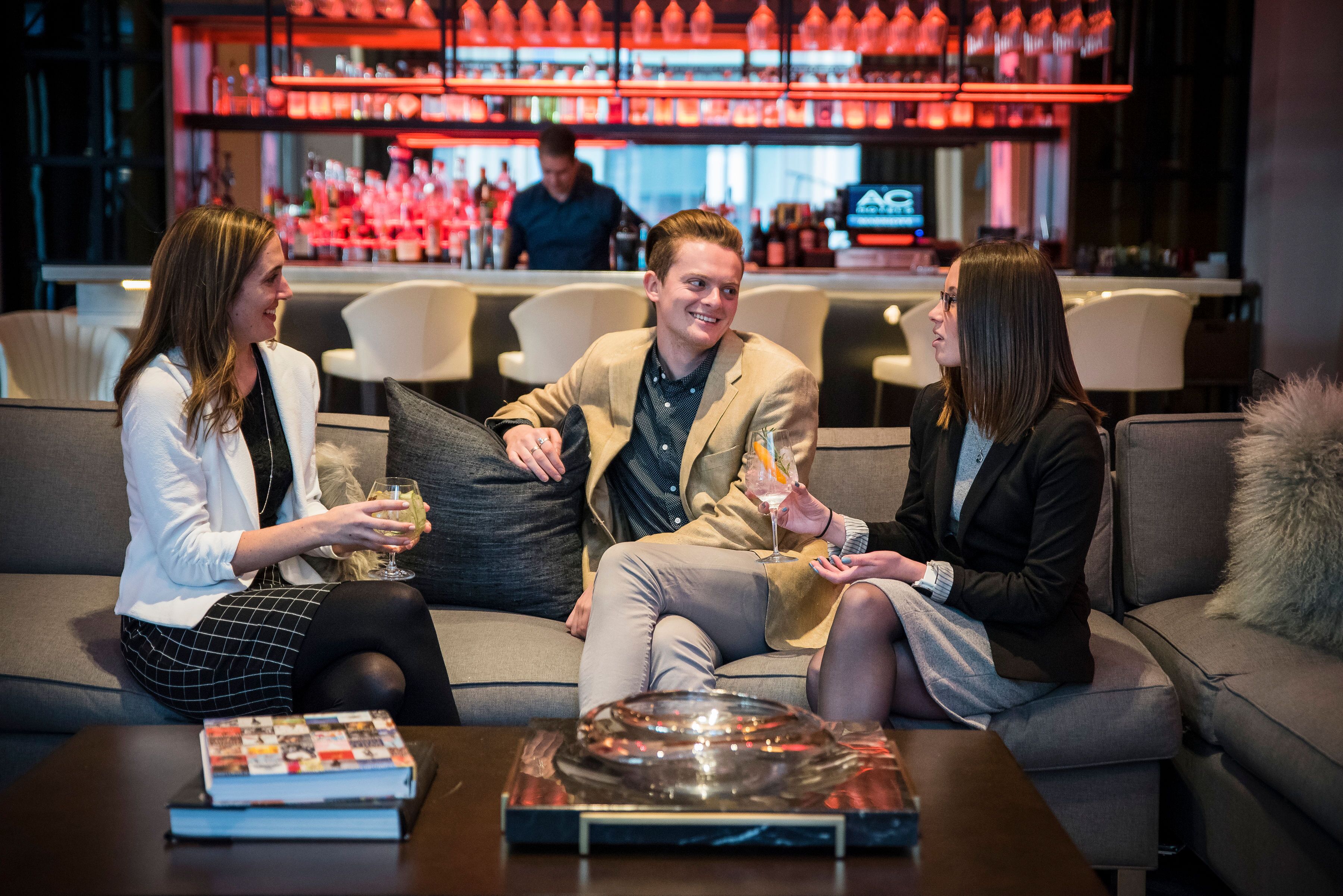 A bar area with a modern design, featuring a bar counter and seating area.