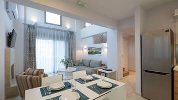 Eco Villa Complex | Living area | 50-inch flat-screen TV with satellite channels, Smart TV, Netflix