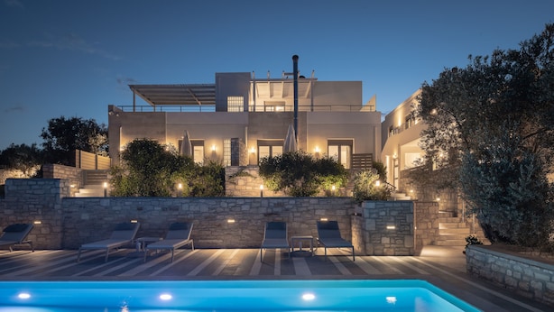 A modern house with a swimming pool, stone walls, and outdoor seating. - Eco Villas (Rethymno)