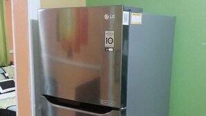 A stainless steel refrigerator with a digital display and a freezer compartment.