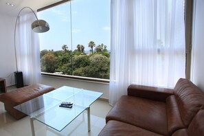 Deluxe Suite, 2 Bedrooms, Sea View | Living room | Flat-screen TV