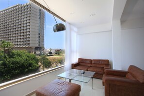 Deluxe Suite, 2 Bedrooms, Sea View | Living room | Flat-screen TV