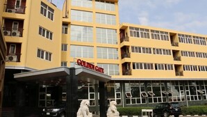 A multi-story hotel with a yellow facade and the name "Golden Gate" visible on the entrance. - Golden Gate Hotel Abuja (Abuja)