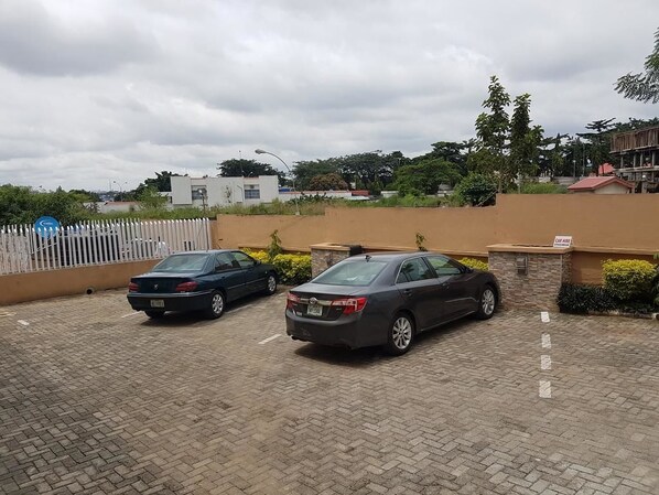 A parking area with two cars parked.
