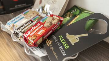 A tray of assorted chocolates and a sign that reads "MAKE UP ROOM".