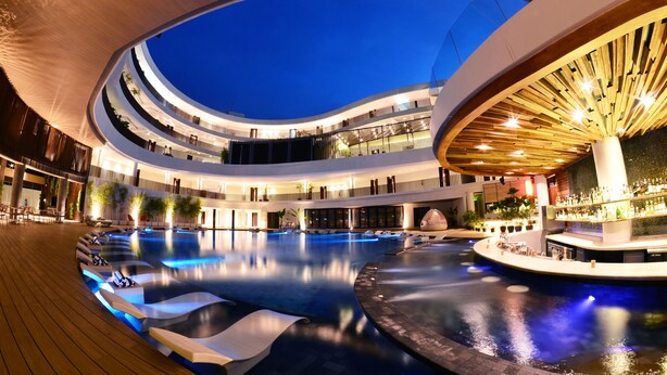A multi-level indoor swimming pool with tiered seating and a bar area. - Hue Hotels and Resorts Boracay Managed by HII (Boracay Island)