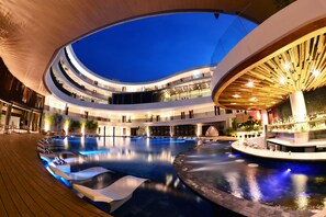 A multi-level indoor swimming pool with tiered seating and a bar area. - Hue Hotels and Resorts Boracay Managed by HII (Boracay Island)