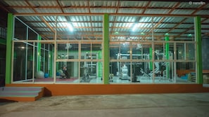 Work out in a well-equipped gym with weight machines and free weights.