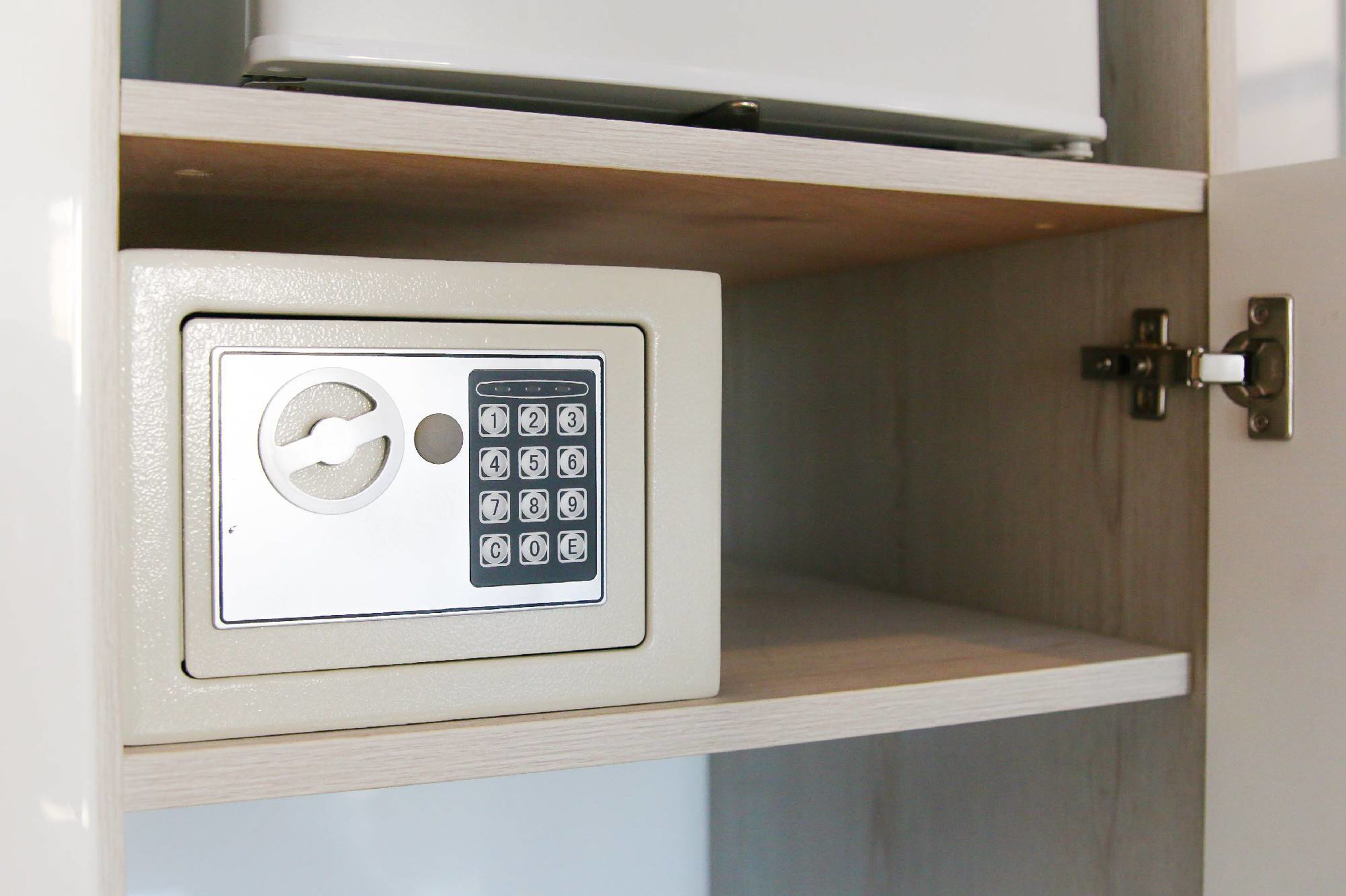 A safe with a keypad and a combination lock.