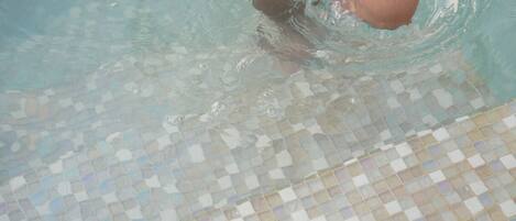 A pool with a tiled floor.