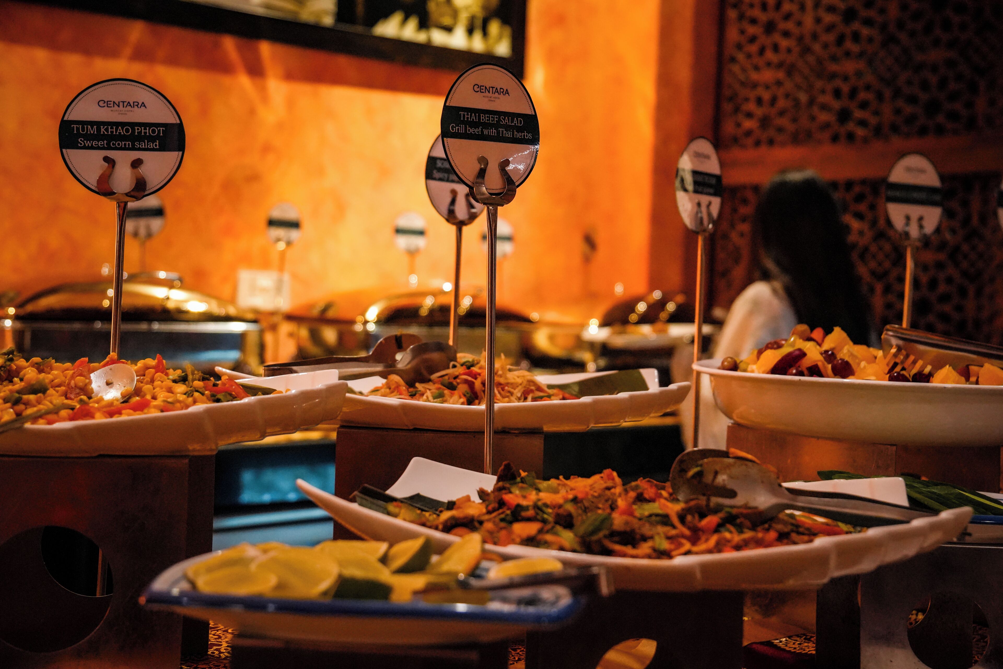 A buffet with various dishes labeled, including 'Sweet corn salad' and 'Thai beef salad'.
