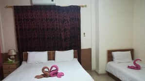 A hotel room with two beds, each with white bedding and a decorative pink swan towel. - Jordan River Hotel (Amman)