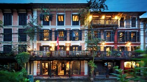 A traditional building with multiple balconies and a courtyard. - The Old Inn (Bandipur)