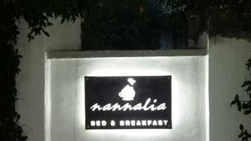 A sign for 'nannalia Bed & Breakfast' with a silhouette of a house and a heart above the name.