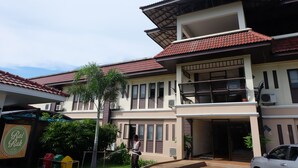 A two-story house with a red-tiled roof, a balcony, and a garage. - Royal Princess City (Lamphun)