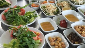 A variety of dishes and condiments arranged on a table, likely for a buffet or tasting event. - Sardunya Otel (Bozcaada)