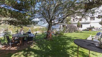 Relax in a serene outdoor setting with a well-maintained lawn, picnic table, and comfortable seating.
