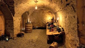 A cellar with wooden doors, barrels, and a wine rack. - Villa Stelvio Bed & Breakfast (Val Muestair)