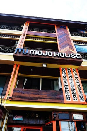 A multi-story building with a prominent 'mu mojo house' sign. - Mojo House (Chiang Mai)