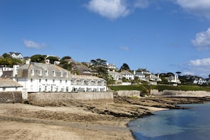 A coastal building with multiple windows and a sign reading "The Idle Rocks".