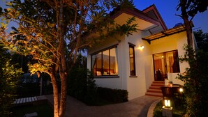 Una casa moderna con un ventanal grande, una escalera y una entrada bien iluminada.