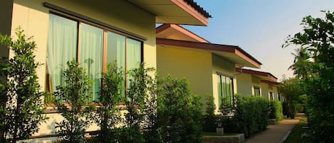 A row of modern, single-story buildings with large windows and a flat roof.