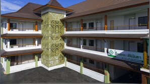 A multi-story hotel with a central tower, balconies, and a sign indicating it is a hotel. - Sirimunta Hotel Chiang Rai (Chiang Rai)