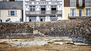 The St Mares Hotel with a stone facade, a balcony, and a view of the sea. - St Mawes Hotel (Truro)