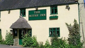 A traditional building with a sign reading "THE MITRE INN".