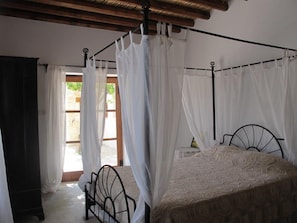 A room with a bed, a chair, and a window with curtains. - SPITI Calliope - ex House of Eleni (Kathikas)