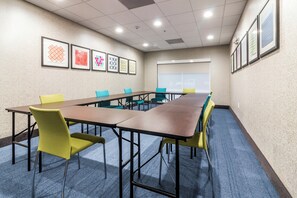 A conference room with a long table, chairs, and framed artwork on the walls. - Holiday Inn Express Villa Rica by IHG (Villa Rica)