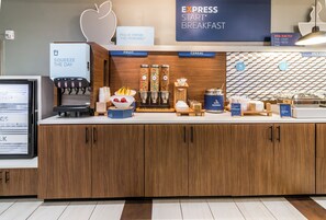 A breakfast station with a coffee machine, fruit bowl, cereal dispensers, and a sign for Express Start Breakfast. - Holiday Inn Express Villa Rica by IHG (Villa Rica)