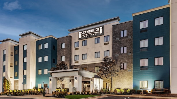 A Staybridge Suites hotel with a modern facade, multiple floors, and a covered entrance area.