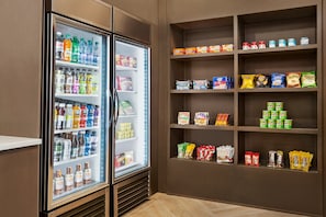 A refrigerated display case with various beverages and snacks.