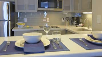 A modern kitchen with stainless steel appliances, a microwave, and a sink.
