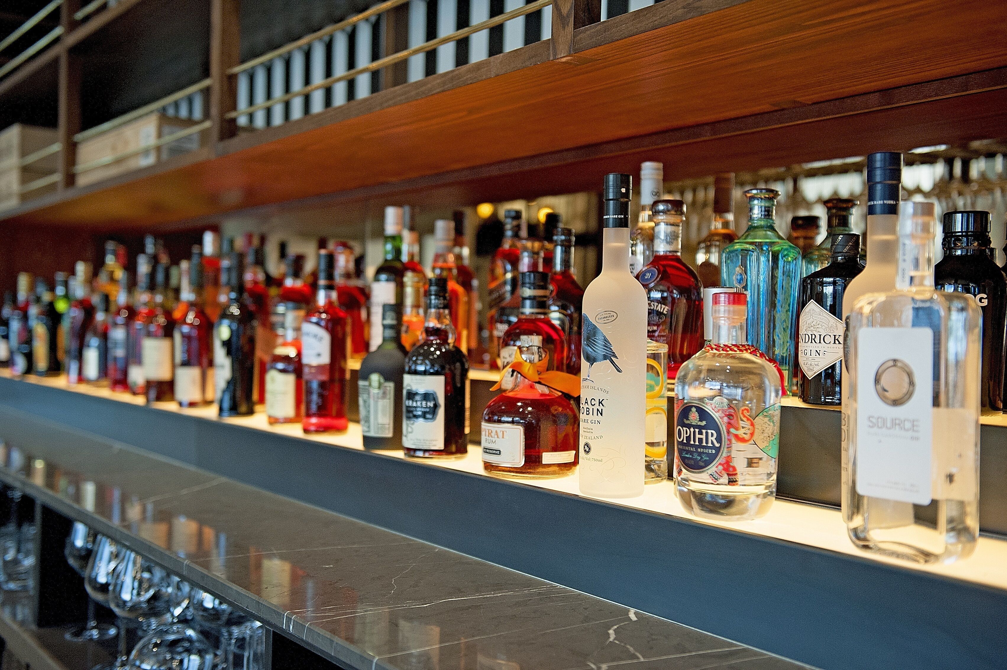 A bar with a variety of liquor bottles displayed on shelves.