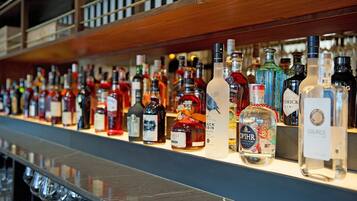 A bar with a variety of liquor bottles displayed on shelves.