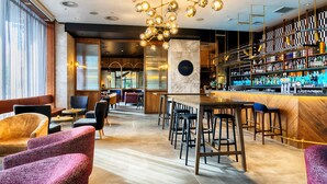 A modern bar area with seating and a bar counter.