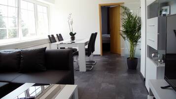 Premium Apartment, 1 Bedroom, Non Smoking, Garden View | Living room | 55-inch flat-screen TV with satellite channels, TV, DVD player