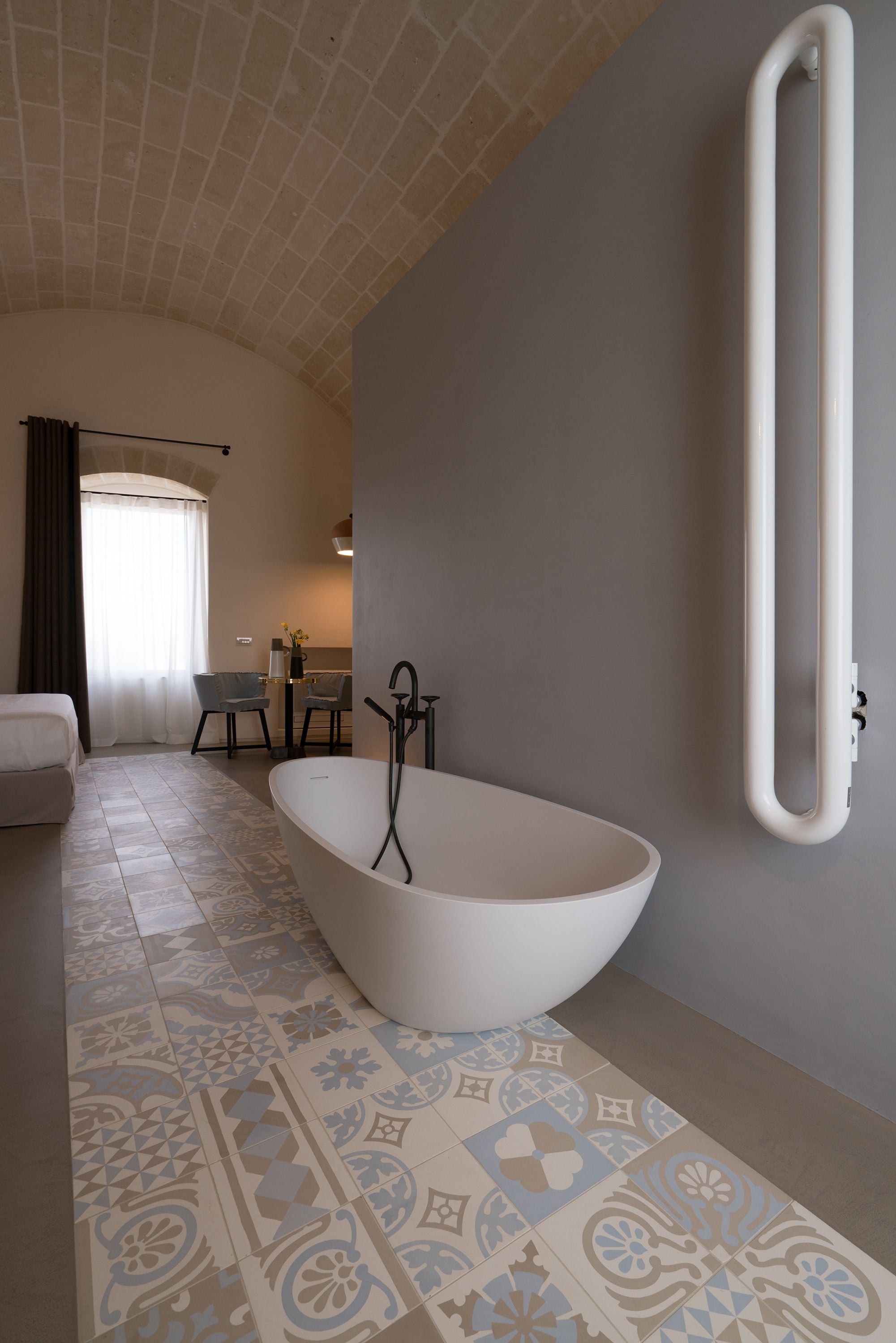 A modern bathroom with a freestanding bathtub, a shower, and a toilet.