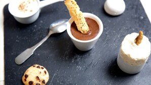 A dessert plate with chocolate mousse, a cookie, and a small bowl of cream. - Hôtel Au Petit Breuil (La Courtine)
