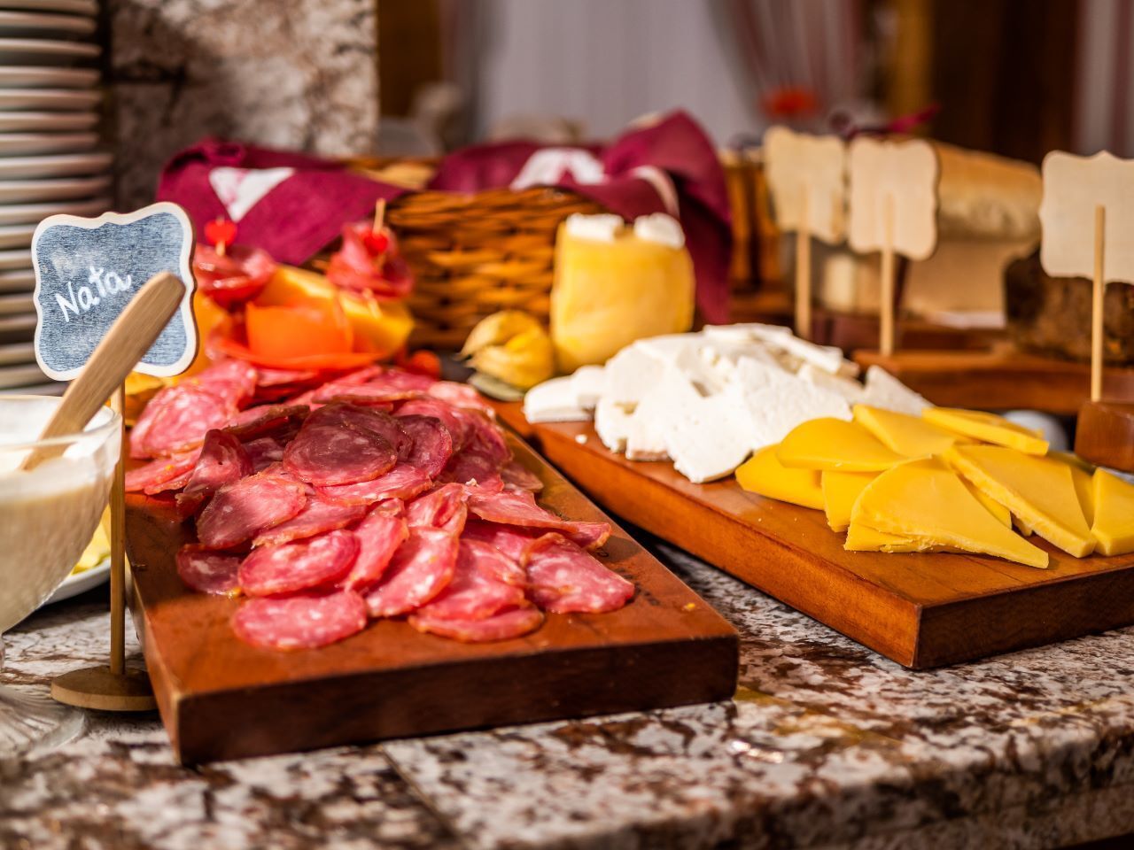 A charcuterie board with various meats and cheeses.