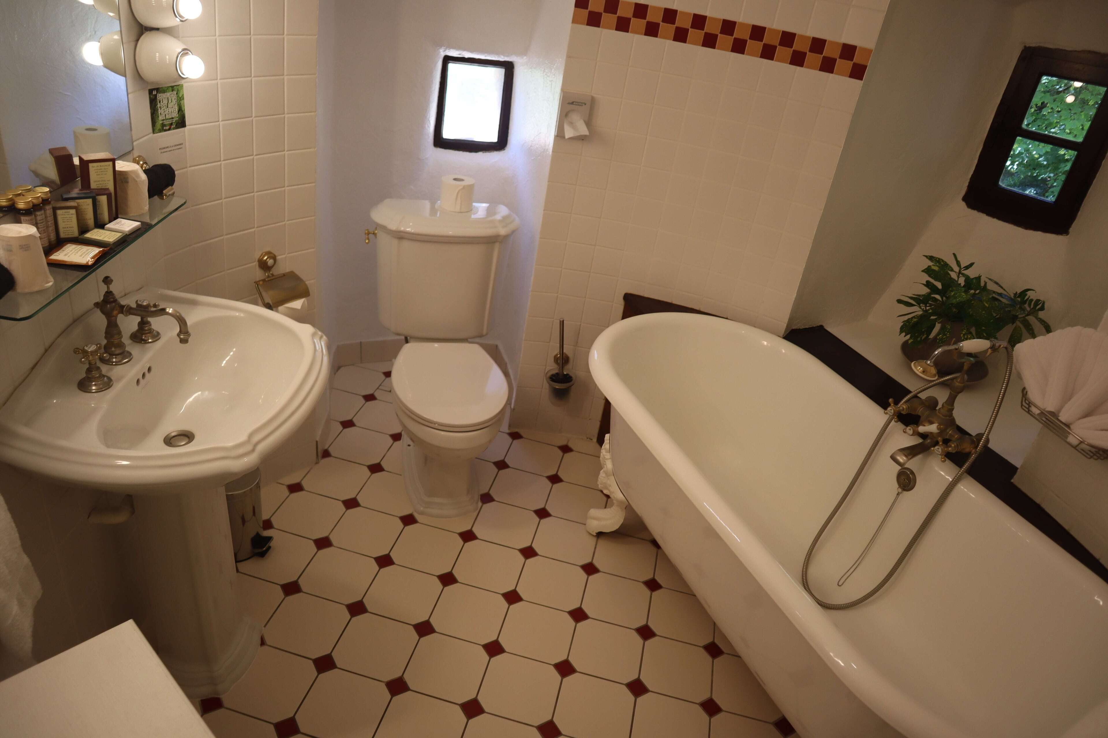 A bathroom with a sink, toilet, and bathtub.