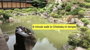 A traditional Japanese garden with a pond, rocks, and a temple in the background. - Kumano House (Kyoto)