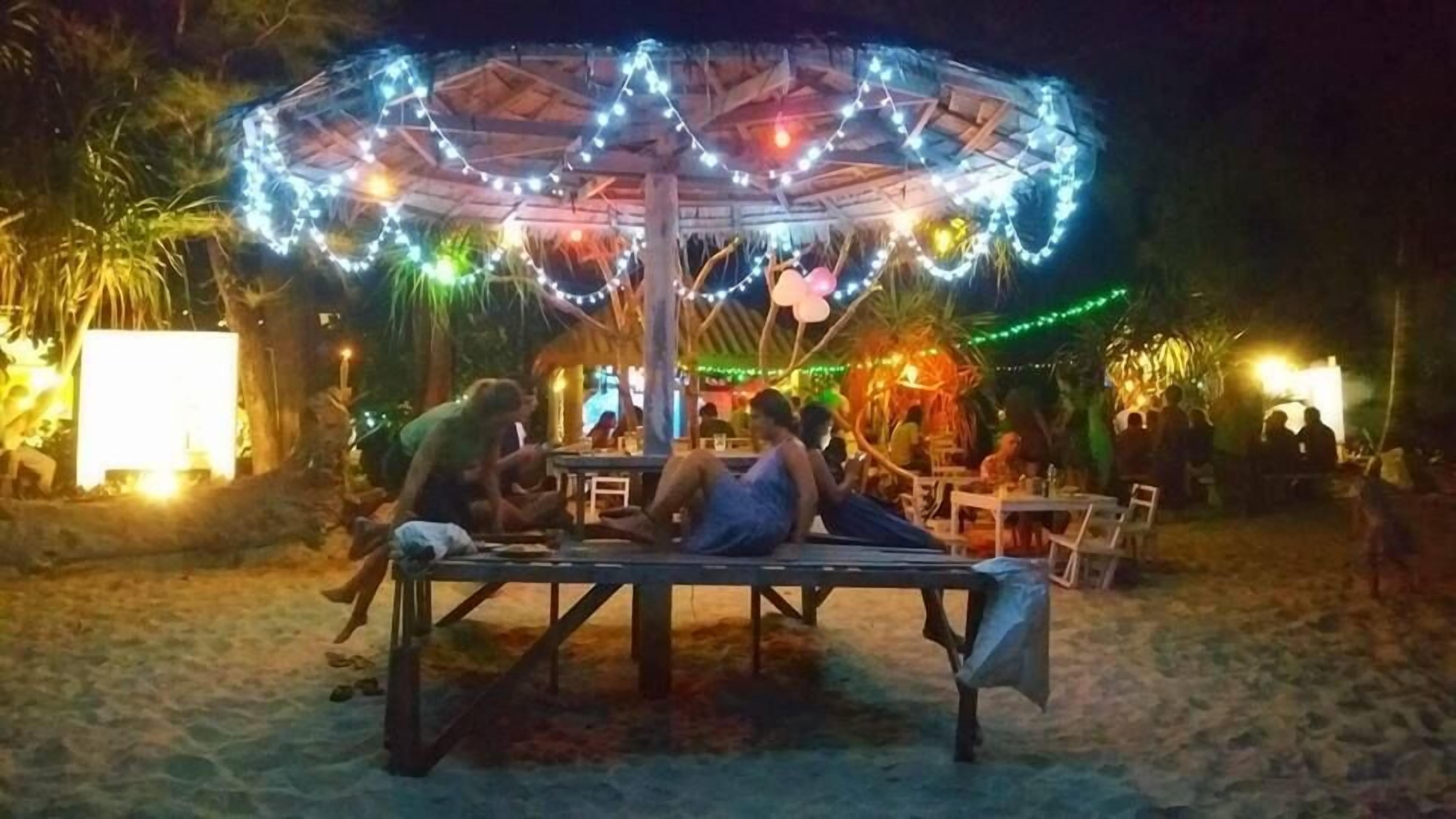 An outdoor seating area with a canopy and string lights.