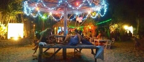 An outdoor seating area with a canopy and string lights.