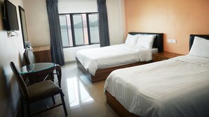 A hotel room with two beds, a desk, and a chair. - Brezza Hotel (Lumut)